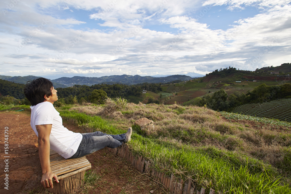 Man watching scenic natural beauty with mountains and fog.