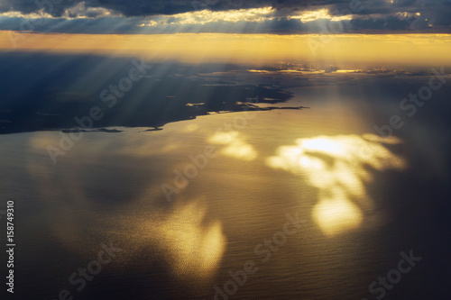 View from the aeroplane, sky with rays coming out from the cloud, © ungvar