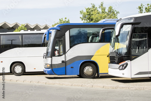 Big tourist buses on parking. Beautiful bus travel transport background. City buses on a parking.