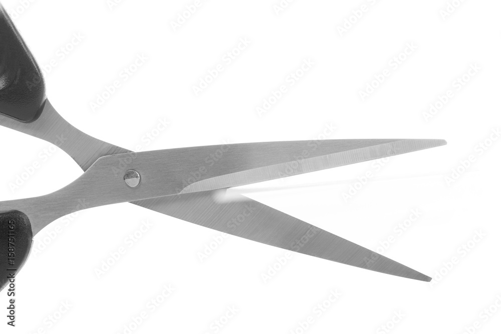 Scissors cutting a paper on the white background. Scissors cutting a paper on the white background.