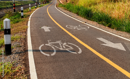 Bicycle lane signage on asphalt road.