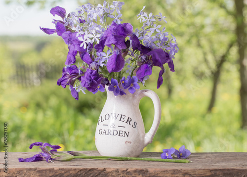 Fototapeta Naklejka Na Ścianę i Meble -  beautiful bouquet with irises on wooden table