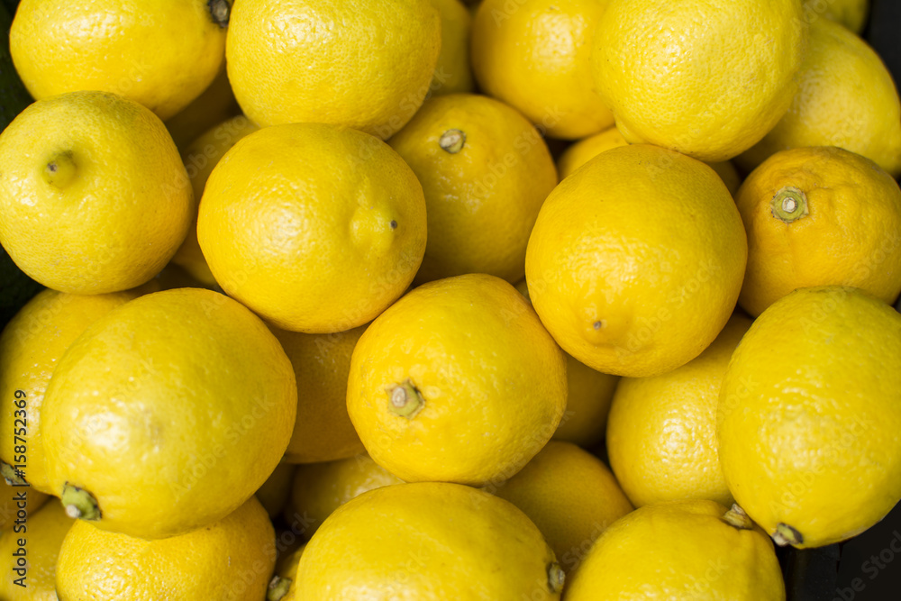 Colorful display of lemons. Pile of lemons.