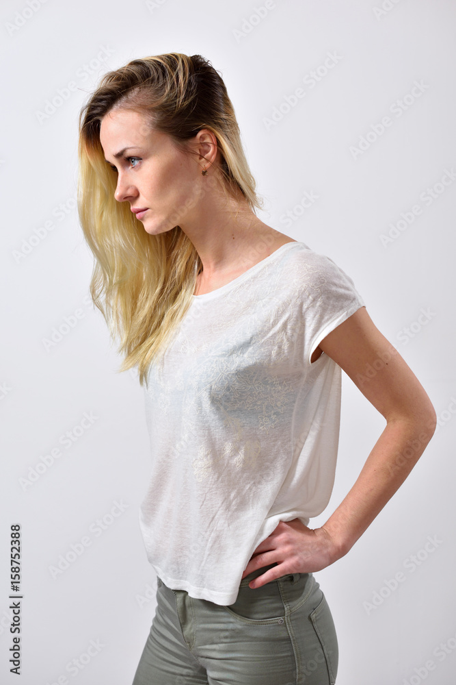 Portrait of a girl, side view, hands on waist Portrait of a girl, side view, hands on waist