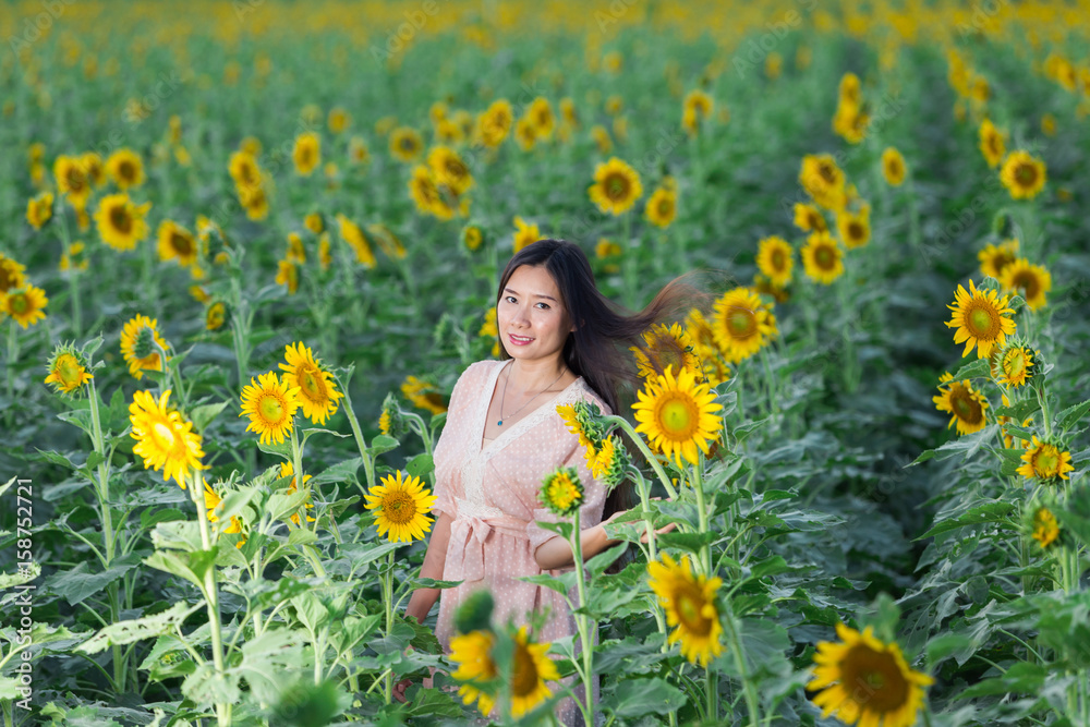 portrait Asia women in sunflower garden portrait Asia women in sunflower garden