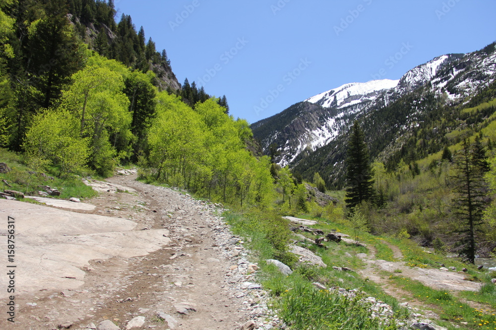 man hiking on mountain trail