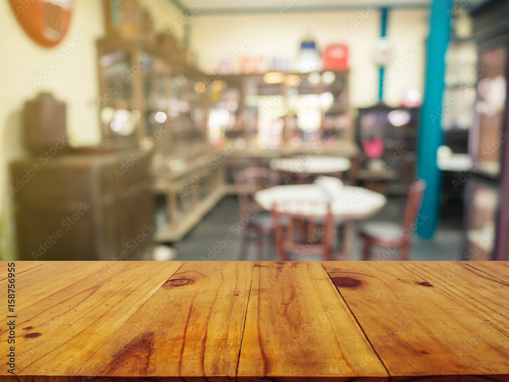 Wooden board empty table in front of blurred background. Perspective brown wood over blur in coffee shop or cafe- can be used for display or montage your products.Mock up your products.Vintage-filter.