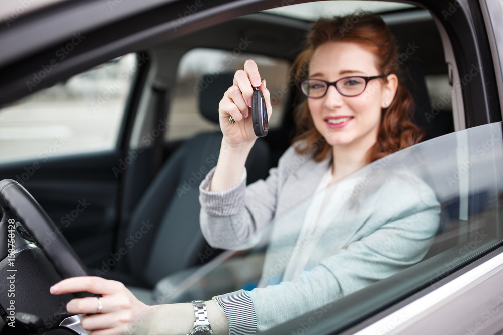 Car rental concept.Woman sitting in car and showing the keys. Car rental concept.Woman sitting in car and showing the keys.