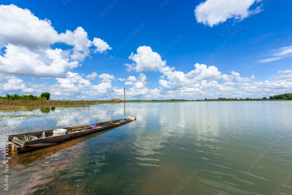 landscape of lake and fishing boat with blue sky