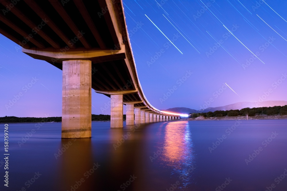 Meteor shower with a bridge at night