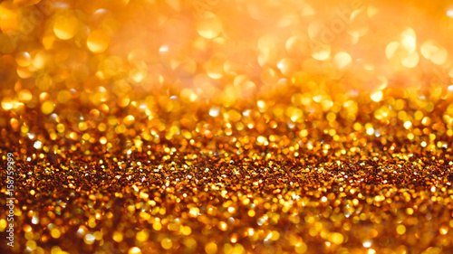 Gold light bokeh texture or glitter lights festive gold background. Christmas abstract template