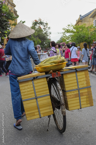 woman walking with a bicycle in Hanoi Vietnam photo