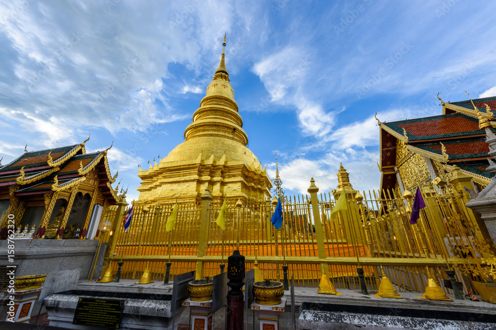 Fototapeta premium Wat Phra That Hariphunchai with blue sky in Lamphun Province, Thailand. Most famous temple in northern of Thailand.