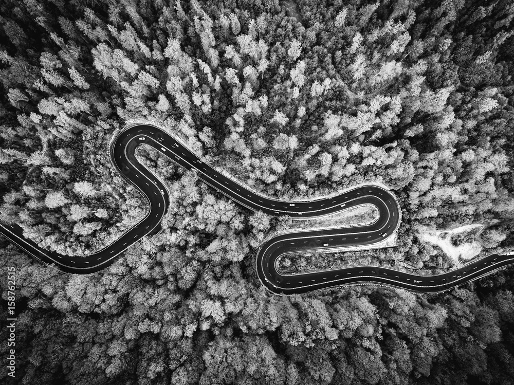 Fotobehang Luchtfoto Wegen Aerial drone view of a curved winding road through the forest. Black and white version #158762515