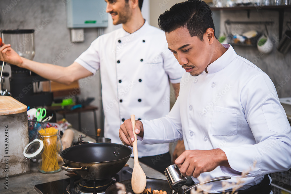 chef preparing food in the kitchen of a restaurant chef preparing food in the kitchen of a restaurant