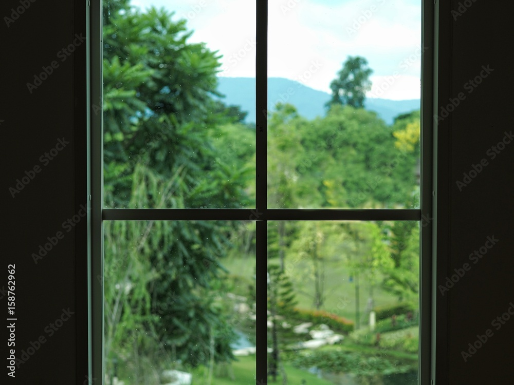 Naklejka premium Silhouette window with garden background behind