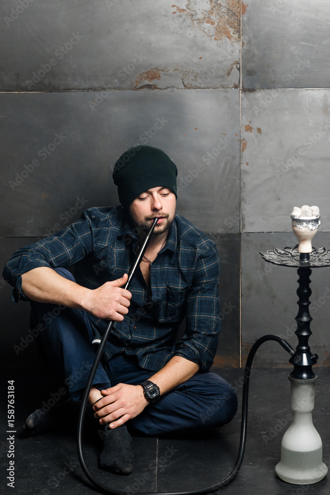 Young handsome bearded man smoking hookah Stock Photo | Adobe Stock