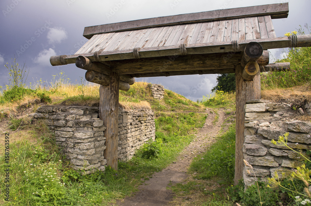 The wooden gate in the ancient Truvor's settlement in cloudy weather (Pskov Oblast).