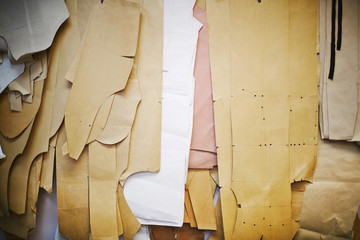 Background shot of many paper patterns on wall in tailoring studio