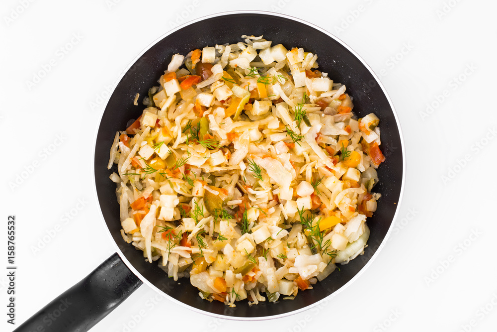Stewed cabbage in frying pan with vegetables