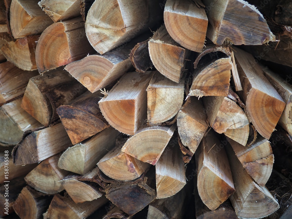 Fototapeta premium Stack of chopped firewood logs background.