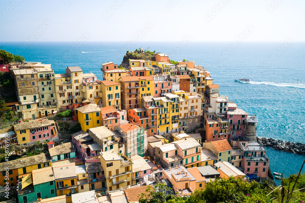 The small fishermen village of Manarola, with its colorful houses hanging to the cliff above the sea, is one of the five town of the Cinque Terre in Liguria.