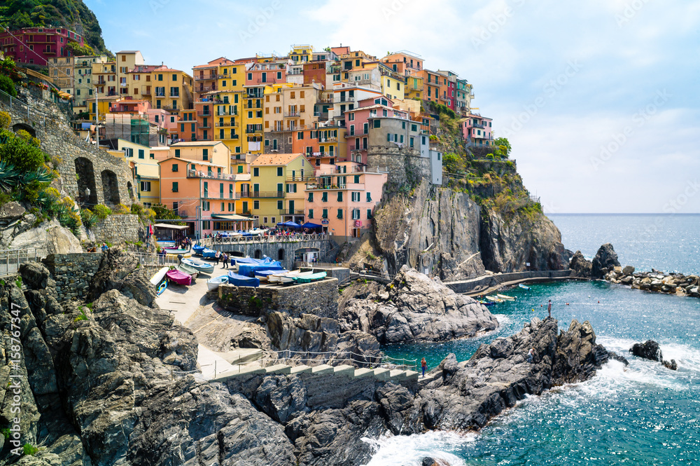 The small fishermen village of Manarola, with its little fishing port and its colorful houses hanging to the cliff, is one of the five town of the Cinque Terre in Liguria.