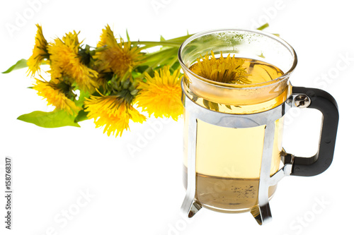 Drink of dandelions in glass cup on white background