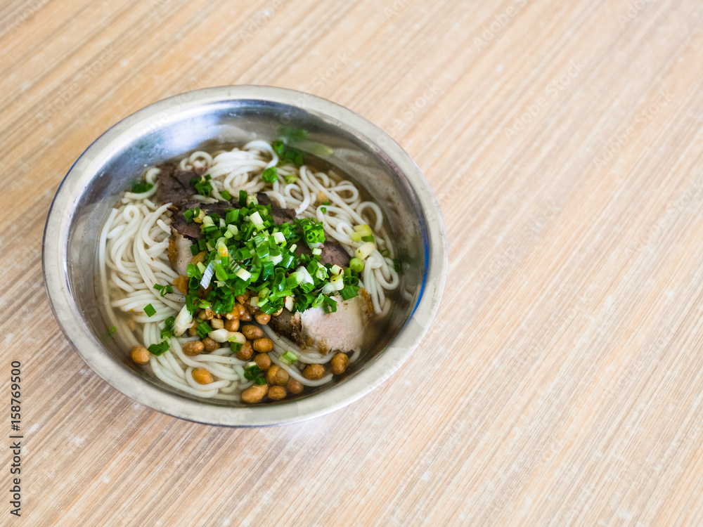 bowl with udon noodles soup with pork in eatery bowl with udon noodles soup with pork in eatery