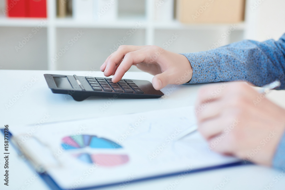 Man analysis business accounting. Business graphs and charts on a white wooden desk with a calculator and pen. Man analysis business accounting. Business graphs and charts on a white wooden desk with a calculator and pen.