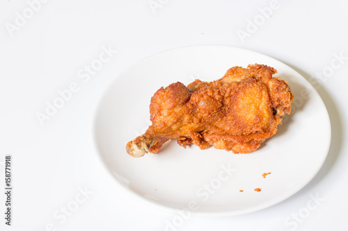 crispy  fried chicken in  the white dish on a wooden table , close up delicious fried chicken , close up