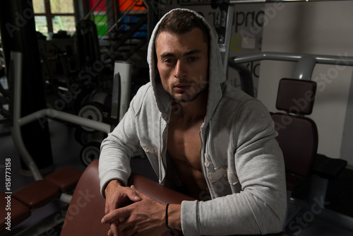 Attractive Young Man Resting In Gym Afther Exercise