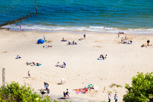 british seaside - summer holiday destination - top view of people on the beach in Bournemouth, Dorset, UK
