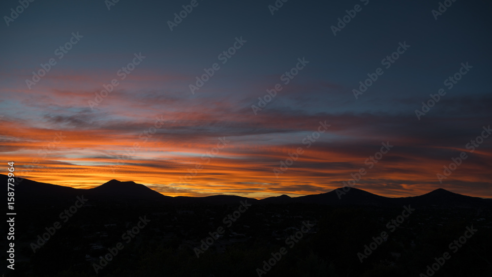 wide shot of a colorful sunset over a mountain range 