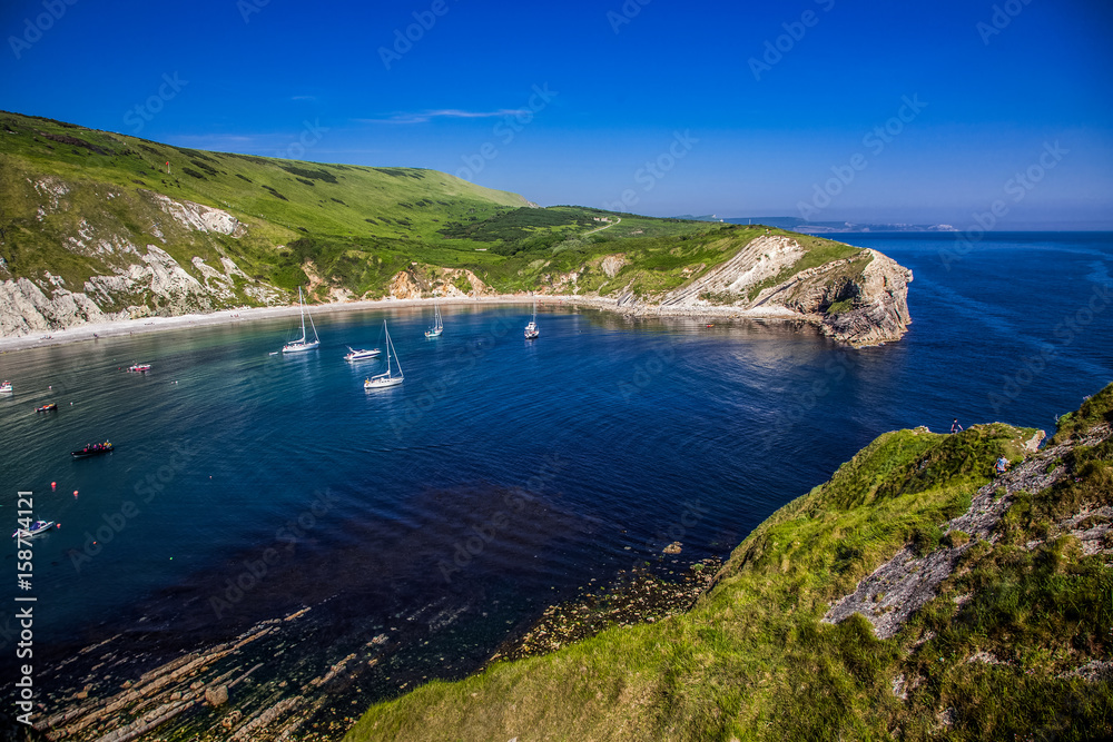 british seaside - summer holiday destination - Lulworth cove on Jurassic coast in southern Devon, UK