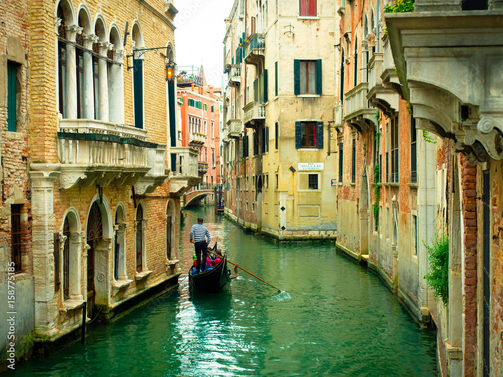 View of the Rio Menuo o de La Verona Canal with gondola in Venice, Italy