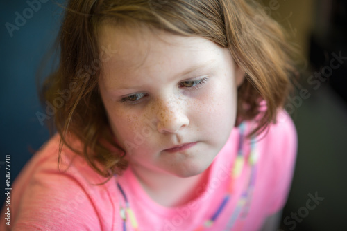 Close Portrait of Girl Thinking Sitting Down