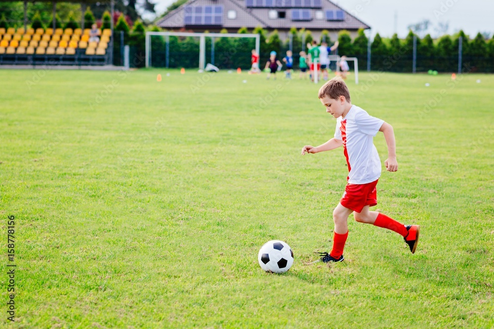 8 years old boy child playing football