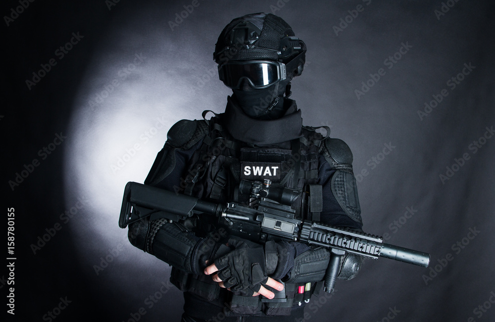 Member Of The SWAT Squad With An Assault Rifle In A Black Uniform On 