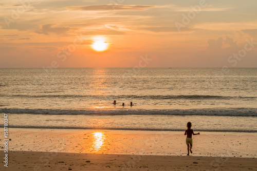 Child runing to the sunset beach (Ko Lanta Thailand)