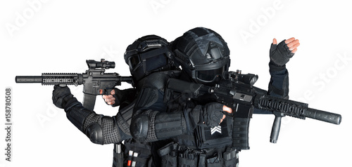 Members of the SWAT squad with an assault rifle in a black uniform on white background. Special weapons and tactics. Special Forces.