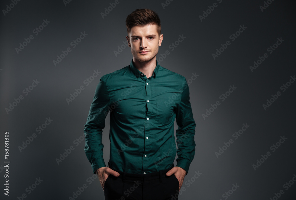 Handsome serious man dressed in shirt posing Handsome serious man dressed in shirt posing