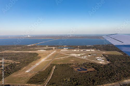 Fototapeta Naklejka Na Ścianę i Meble -  Aerial view of the airport in Titusville, behind the building Nasa at Kennedy Space Center, Cape Canaveral. Florida, USA