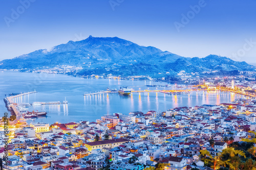 Zante - Zakinthos islnad, capital city, view from above, twilight scenery, panoramic aspect ratio photography. Zante is famous and popular summer resort. Greece, EU country.