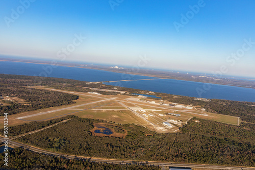 Fototapeta Naklejka Na Ścianę i Meble -  Aerial view of the airport in Titusville, behind the building Nasa at Kennedy Space Center, Cape Canaveral. Florida, USA