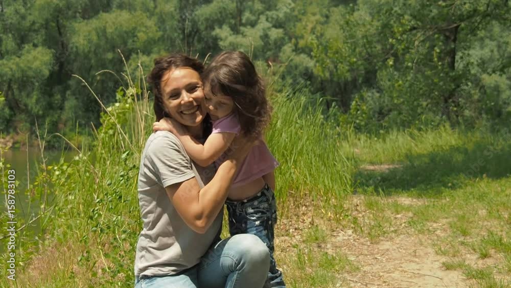 Mom hugs the child. The little girl runs into her mother's arms. Mom hugs the child. The little girl runs into her mother's arms.