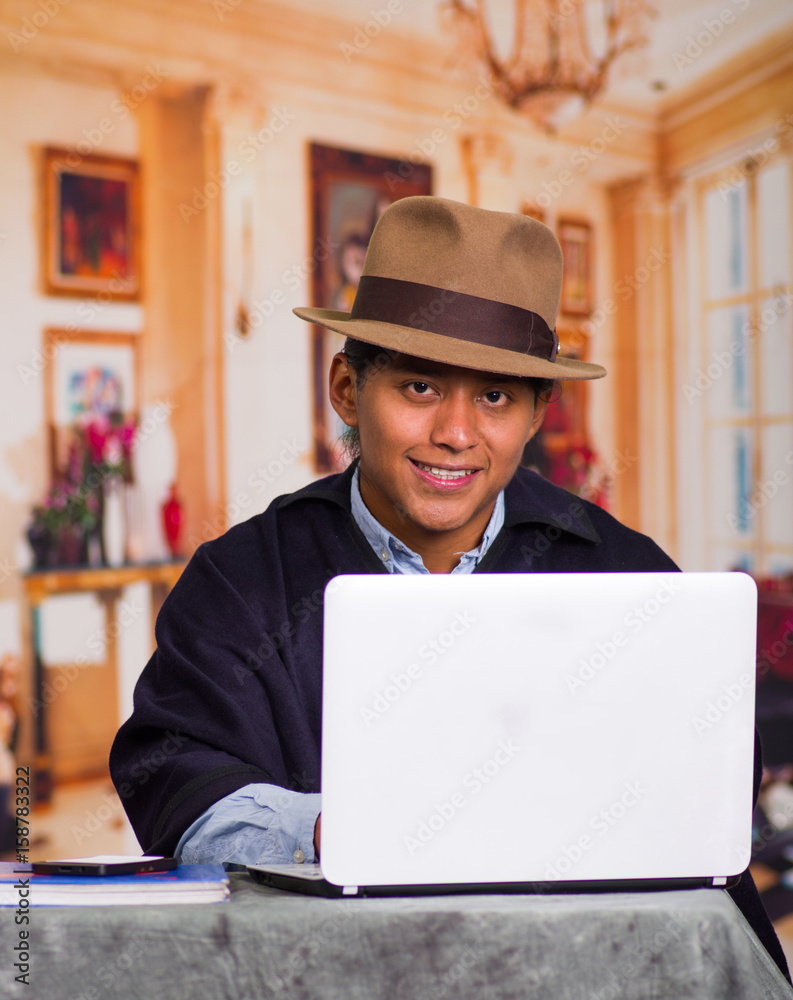 Close up portrait of indigenous young latin man using laptop Close up portrait of indigenous young latin man using laptop
