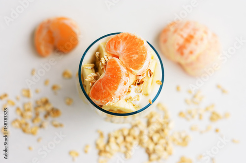 Yoghurt with fruit, banana and cereal for breakfast