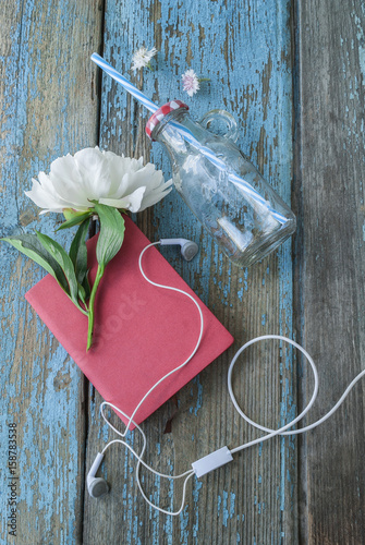 Notebook and white flower on blue wooden background texture photo