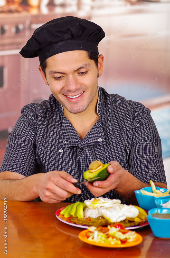 Man in kitchen cooking dish, churrasco ecuatorian cuisine Man in kitchen cooking dish, churrasco ecuatorian cuisine